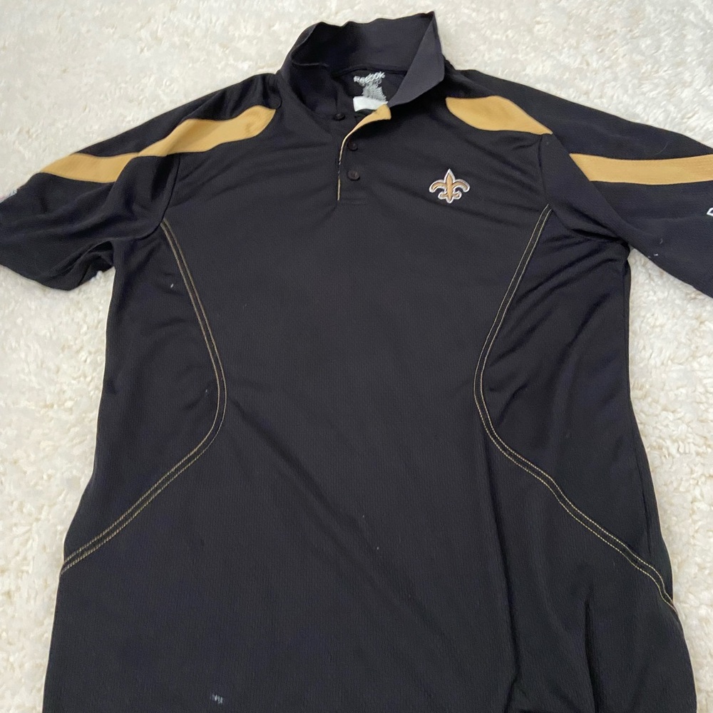 Saints Collard Shirt. The white spots on it are loose cotton pieces. Not stains